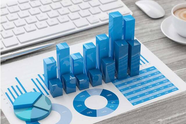 Bookkeeping reports and charts next to a keyboard