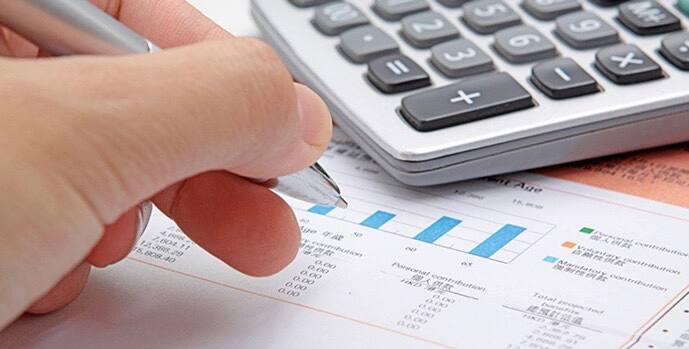 Checking tax figures on a statement next to a calculator