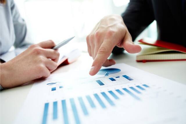 Reviewing company financial reports with a pen