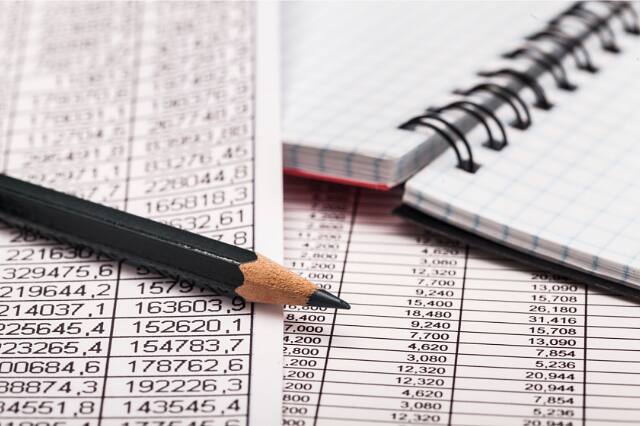 Spreadsheet of figures with a pencil, preparing financial statements