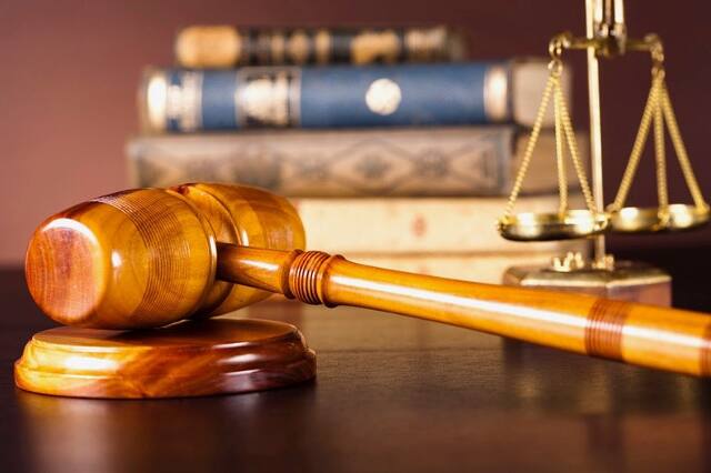 Judge's gavel, law books and scales of justice